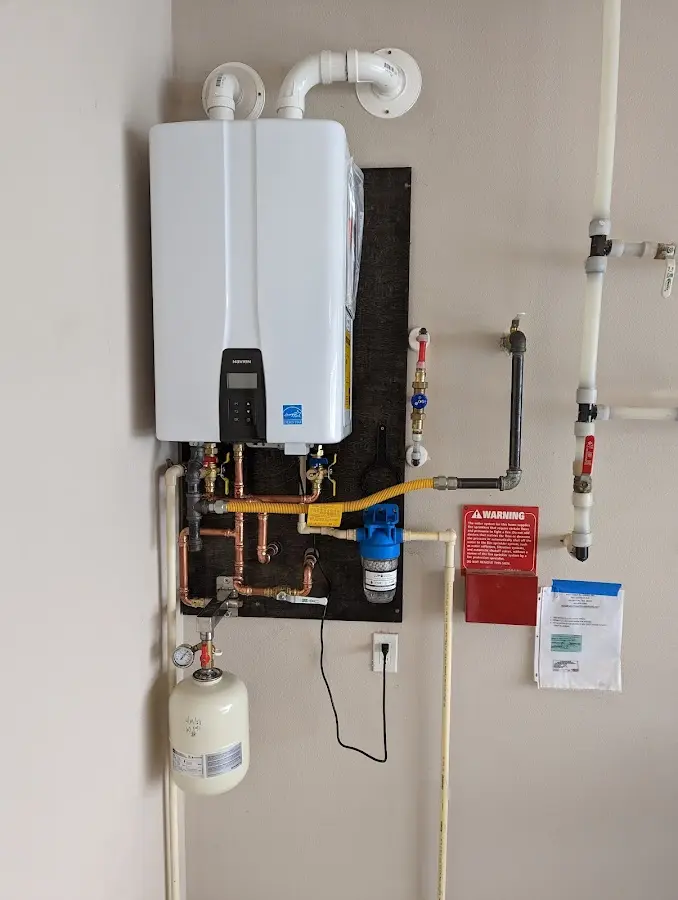 Professional plumber installing copper piping in a Spout Springs home